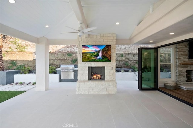 view of patio / terrace featuring ceiling fan, a grill, area for grilling, and an outdoor stone fireplace