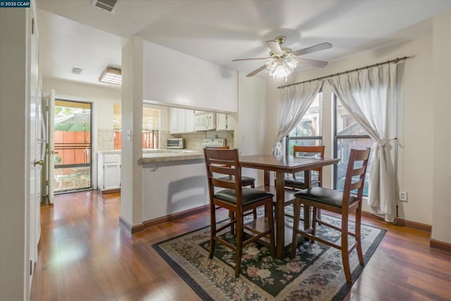 dining room with ceiling fan and dark hardwood / wood-style flooring