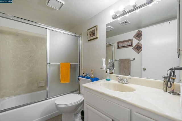 full bathroom with vanity, combined bath / shower with glass door, and toilet