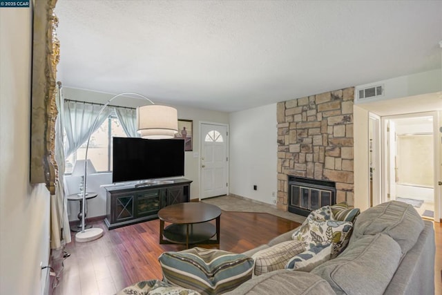 living room with hardwood / wood-style flooring and a fireplace