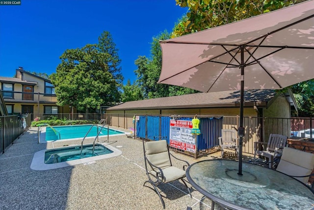 view of swimming pool with a community hot tub