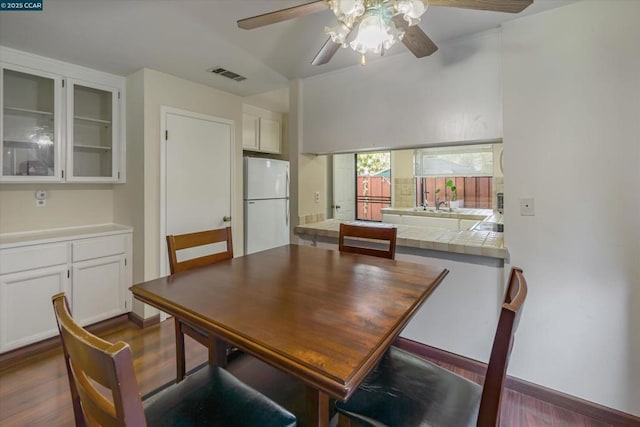 dining area with dark hardwood / wood-style flooring and ceiling fan