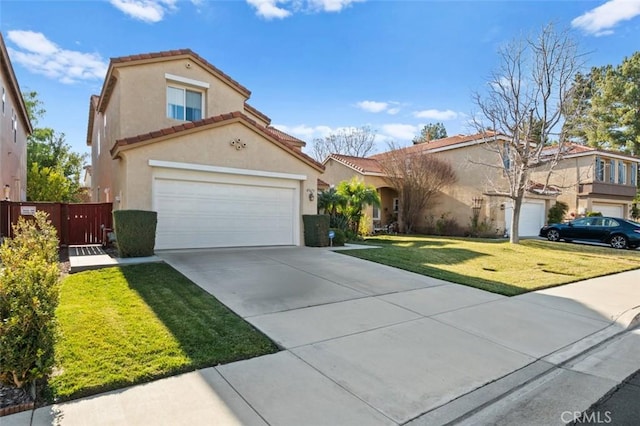 mediterranean / spanish home with a garage and a front lawn