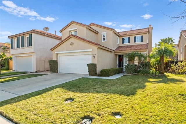 mediterranean / spanish home with a garage and a front yard