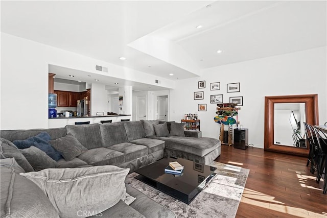 living room with lofted ceiling and dark hardwood / wood-style flooring