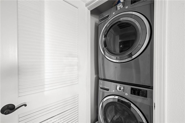 washroom featuring stacked washer and dryer