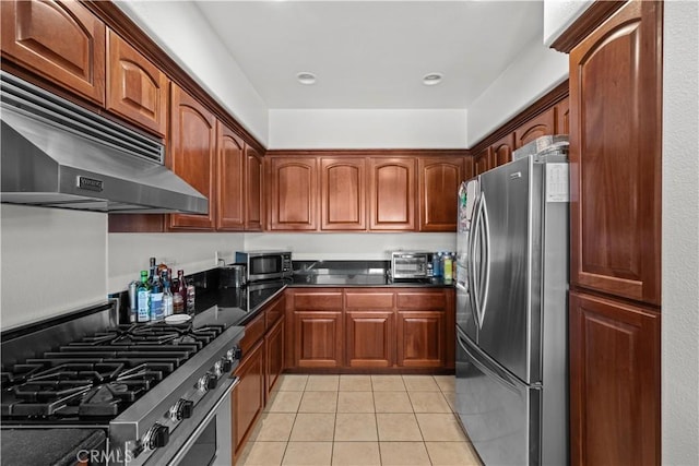 kitchen with extractor fan, light tile patterned flooring, and appliances with stainless steel finishes