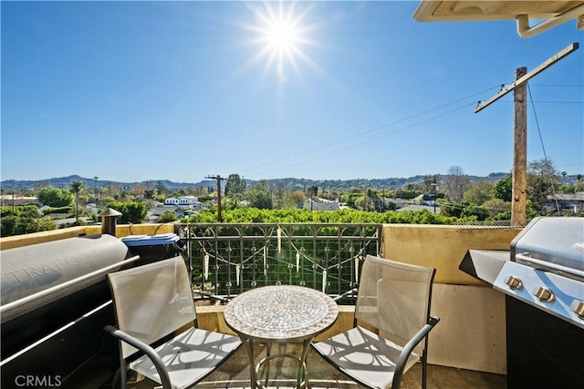 balcony featuring a mountain view and grilling area