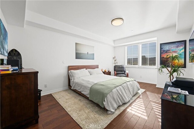 bedroom with dark hardwood / wood-style floors