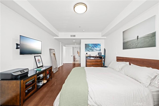 bedroom with dark hardwood / wood-style floors