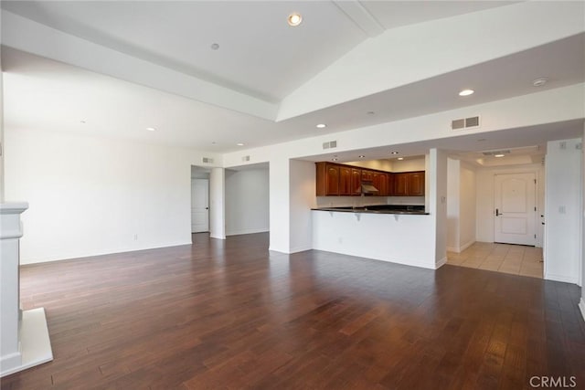 12449 Kling St Unit Ph2, Studio City, CA 91604 - unfurnished living room with hardwood / wood-style flooring, vaulted ceiling, recessed lighting, and baseboards