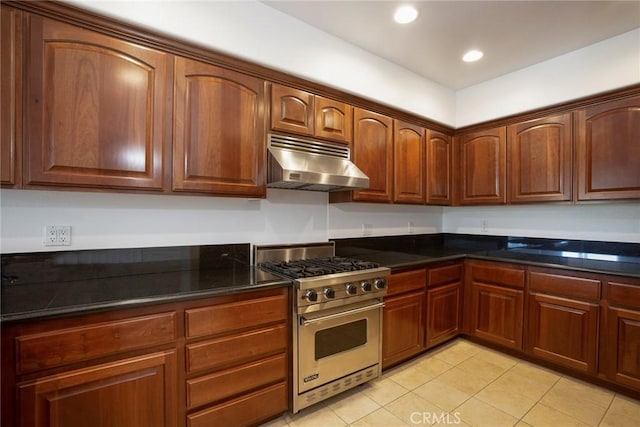12449 Kling St Unit Ph2, Studio City, CA 91604 - kitchen with under cabinet range hood, designer stove, light tile patterned flooring, recessed lighting, and dark stone countertops