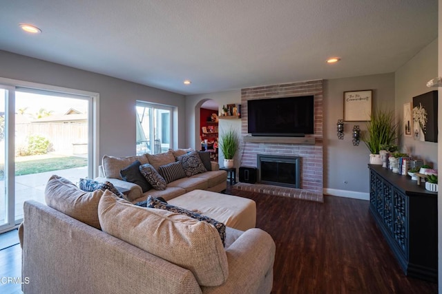 living room featuring dark hardwood / wood-style floors and a fireplace