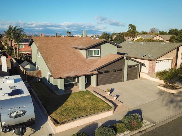 view of front of home featuring a garage and a front lawn