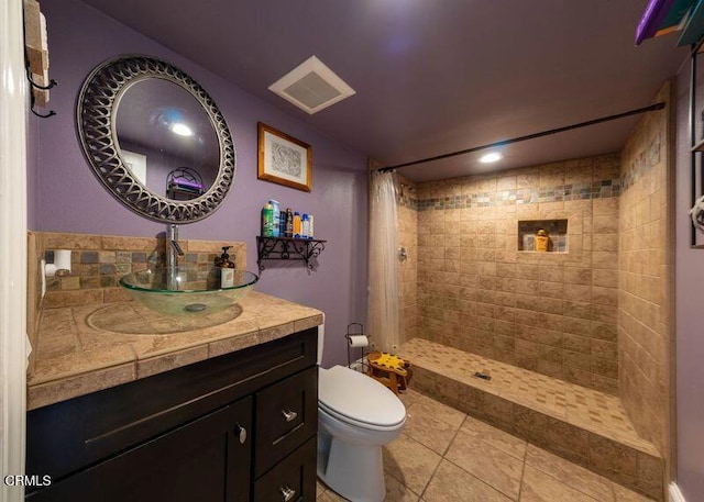 bathroom with vanity, a shower with curtain, tile patterned floors, and toilet