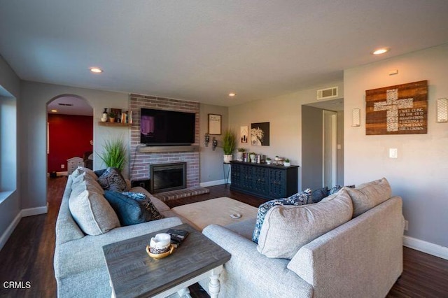 living room featuring a fireplace and dark hardwood / wood-style flooring