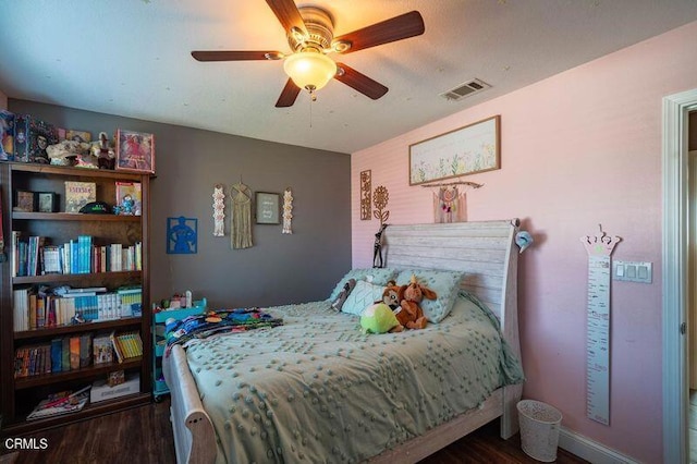 bedroom with dark wood-type flooring and ceiling fan