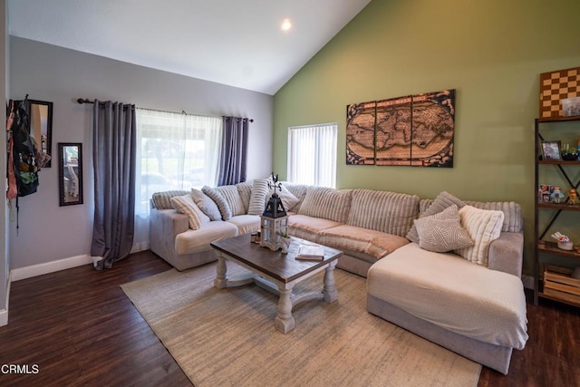 living room with dark hardwood / wood-style flooring and high vaulted ceiling