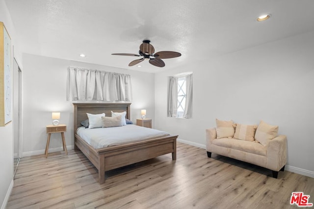 bedroom featuring ceiling fan and light hardwood / wood-style floors