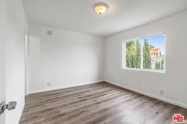 unfurnished room featuring wood-type flooring