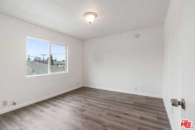 unfurnished room with dark hardwood / wood-style floors