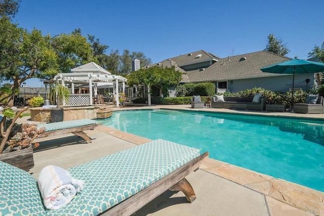 view of pool featuring a pergola, an outdoor hangout area, and a patio