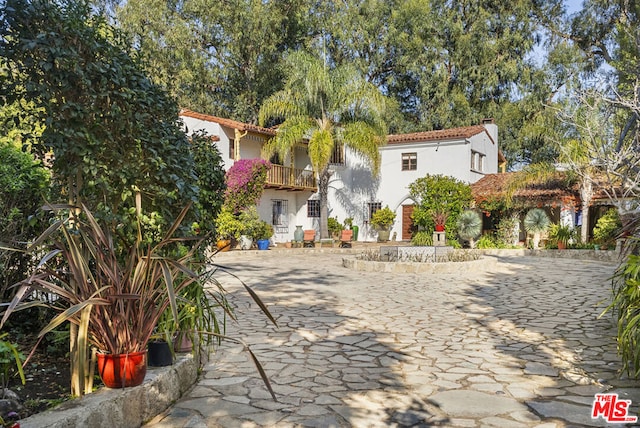 mediterranean / spanish-style home featuring a patio and a balcony