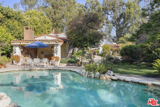 view of swimming pool with a patio area