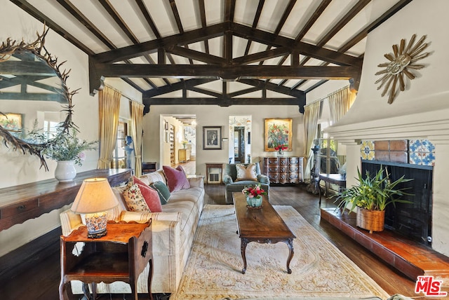 living room featuring beamed ceiling, wood-type flooring, high vaulted ceiling, and a high end fireplace