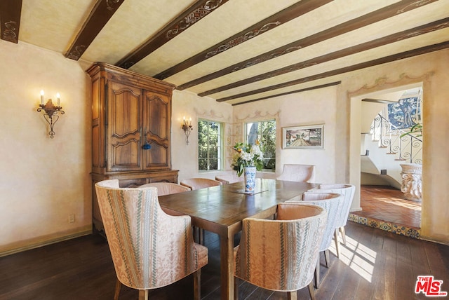 dining room featuring dark hardwood / wood-style floors and beam ceiling