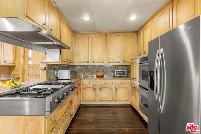 kitchen with dark wood-type flooring, stainless steel appliances, light stone counters, tasteful backsplash, and light brown cabinetry