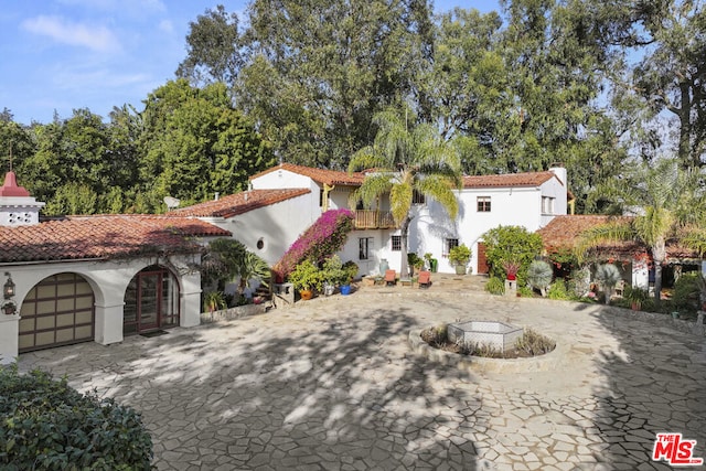 mediterranean / spanish home featuring a fire pit