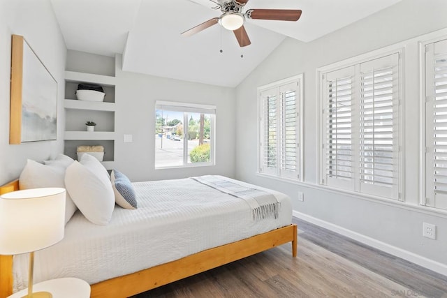 bedroom with hardwood / wood-style flooring, vaulted ceiling, and ceiling fan