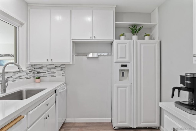 kitchen with dishwasher, white cabinetry, sink, decorative backsplash, and paneled fridge