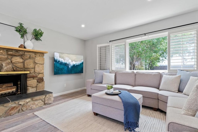 living room featuring a fireplace and light hardwood / wood-style flooring