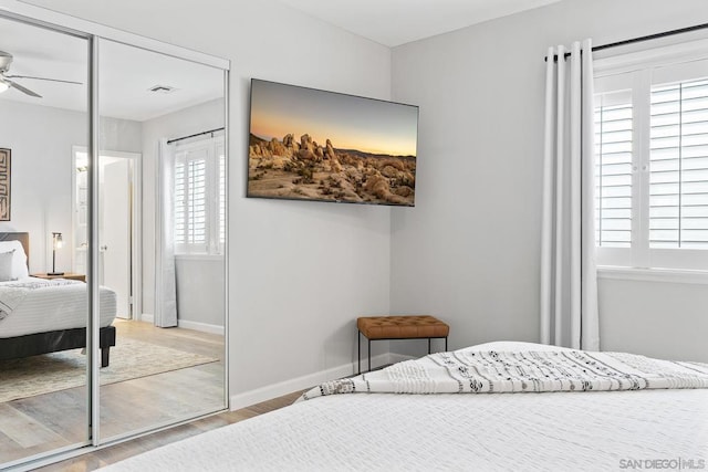 bedroom with a closet and light hardwood / wood-style flooring