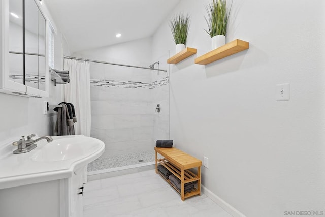 bathroom with vanity, lofted ceiling, and walk in shower