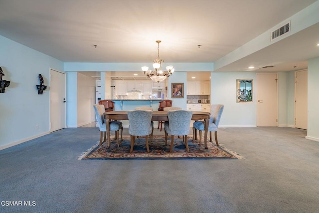 dining room featuring dark carpet and a notable chandelier