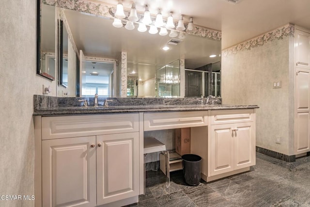 bathroom featuring vanity and a shower with shower door