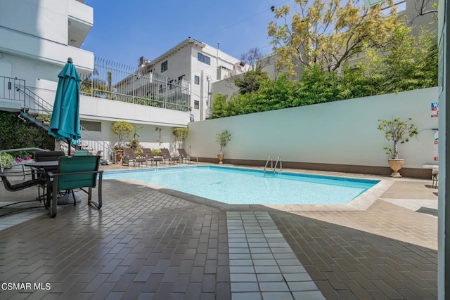 view of swimming pool with a patio area