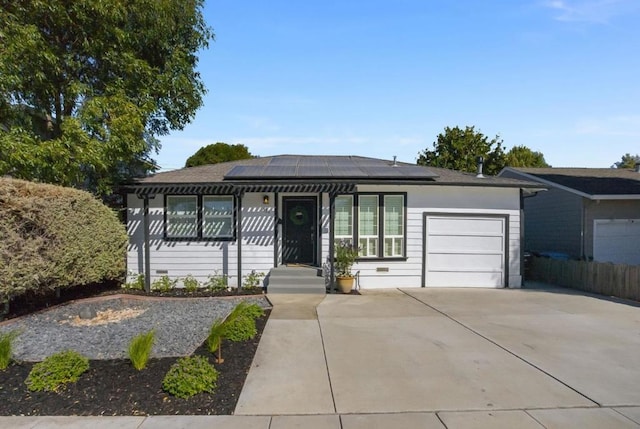 view of front of house featuring a garage and solar panels