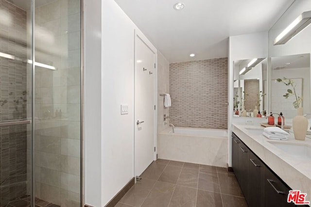 bathroom with tile patterned flooring, vanity, and shower with separate bathtub