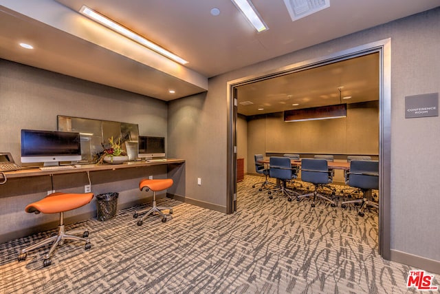 office space featuring carpet flooring and built in desk