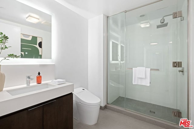 bathroom with vanity, an enclosed shower, and toilet