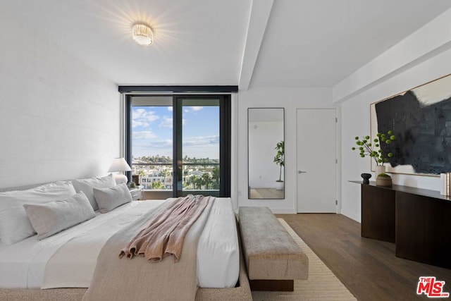 bedroom with dark hardwood / wood-style flooring and beamed ceiling