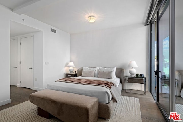 bedroom with dark wood-type flooring and access to exterior