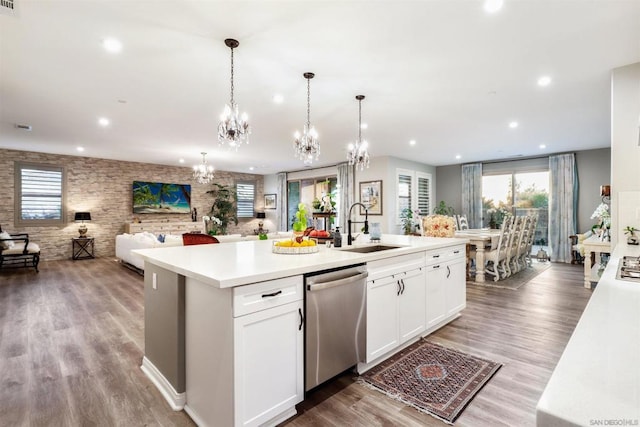 kitchen with dishwasher, an island with sink, hanging light fixtures, and white cabinets