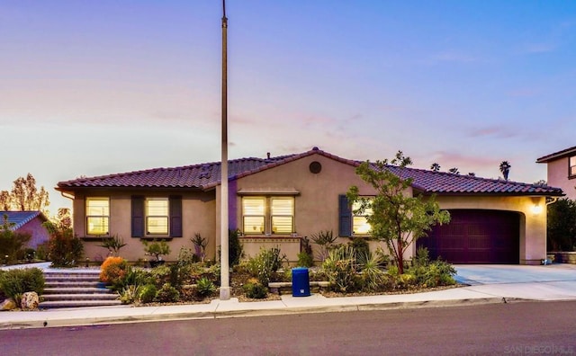 mediterranean / spanish-style home with a garage