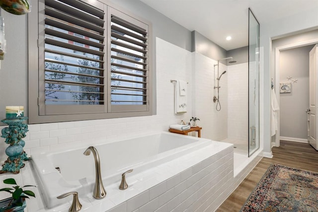 bathroom with hardwood / wood-style flooring and plus walk in shower