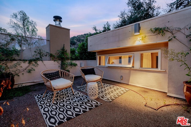 view of patio terrace at dusk